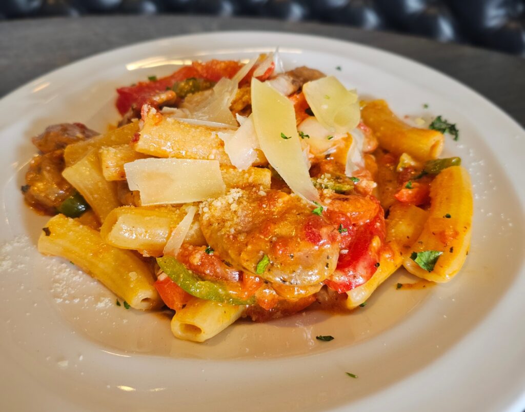 Sausage Abruzzi Pasta: Sweet Italian sausage sautéed with roasted peppers, garlic and crushed red pepper. Tossed with house-made tomato basil marinara, fresh rigatoni pasta and parmesan cheese.