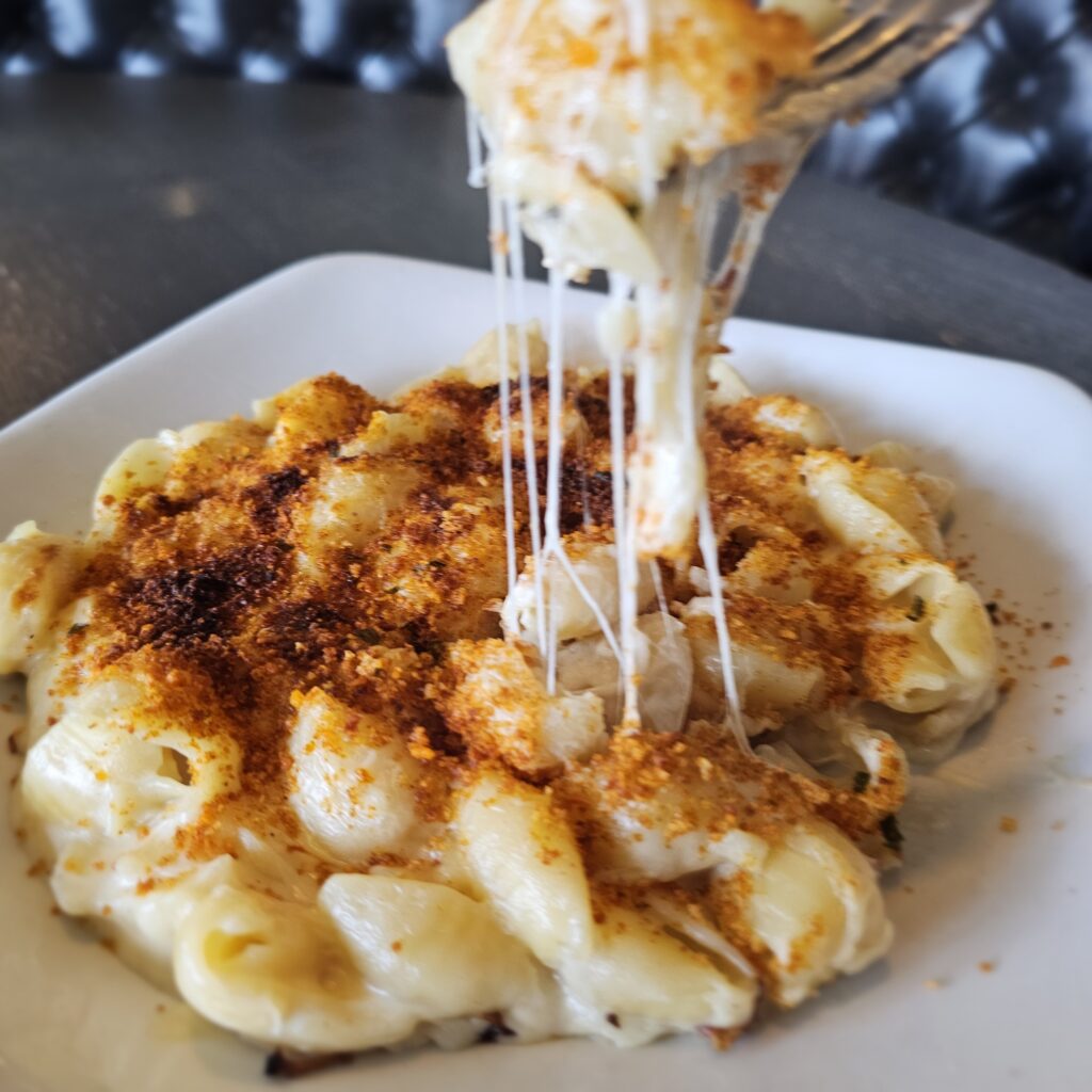 Mac & Cheese: Shell pasta tossed in our one-of-a-kind cheese blend; topped with seasoned breadcrumbs & baked to perfection.