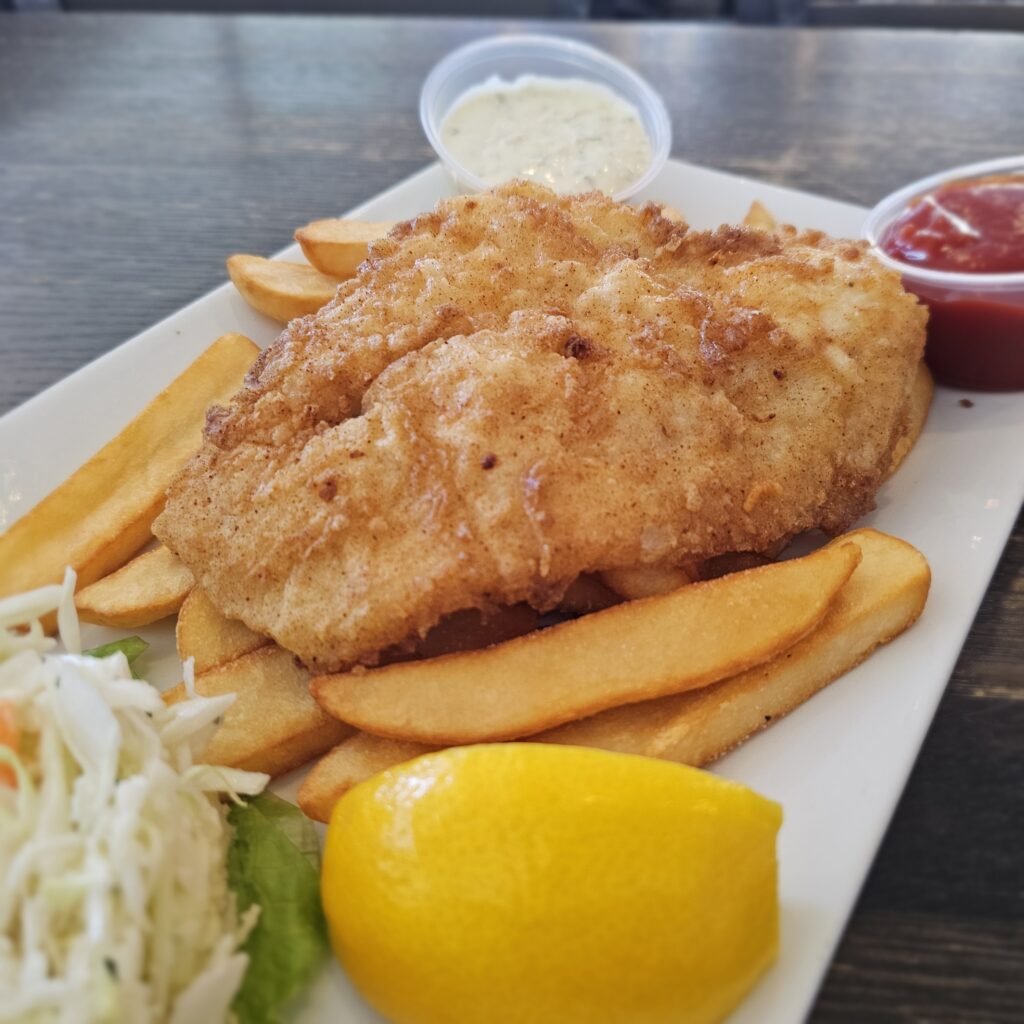 Fish & Chips: Atlantic cod lightly breaded and deep fried, served with steak fries, creamy coleslaw, and tartar sauce.
