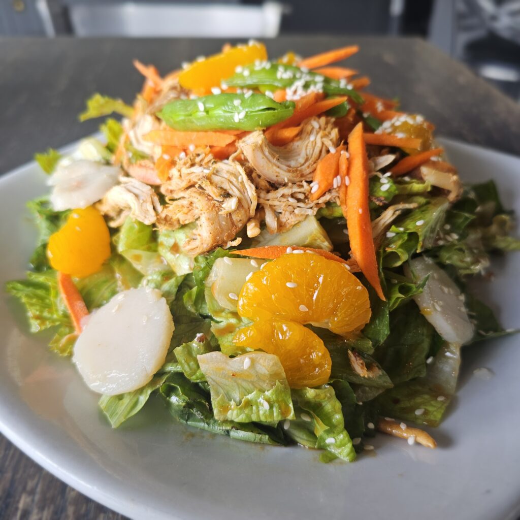 Thai Peanut Chicken Salad: Pulled roasted chicken with crisp romaine, shredded carrots, water chestnuts, snap peas, roasted peanuts & mandarin oranges tossed with spicy Thai peanut sauce, sprinkled with sesame seeds & crispy chow Mein noodles.