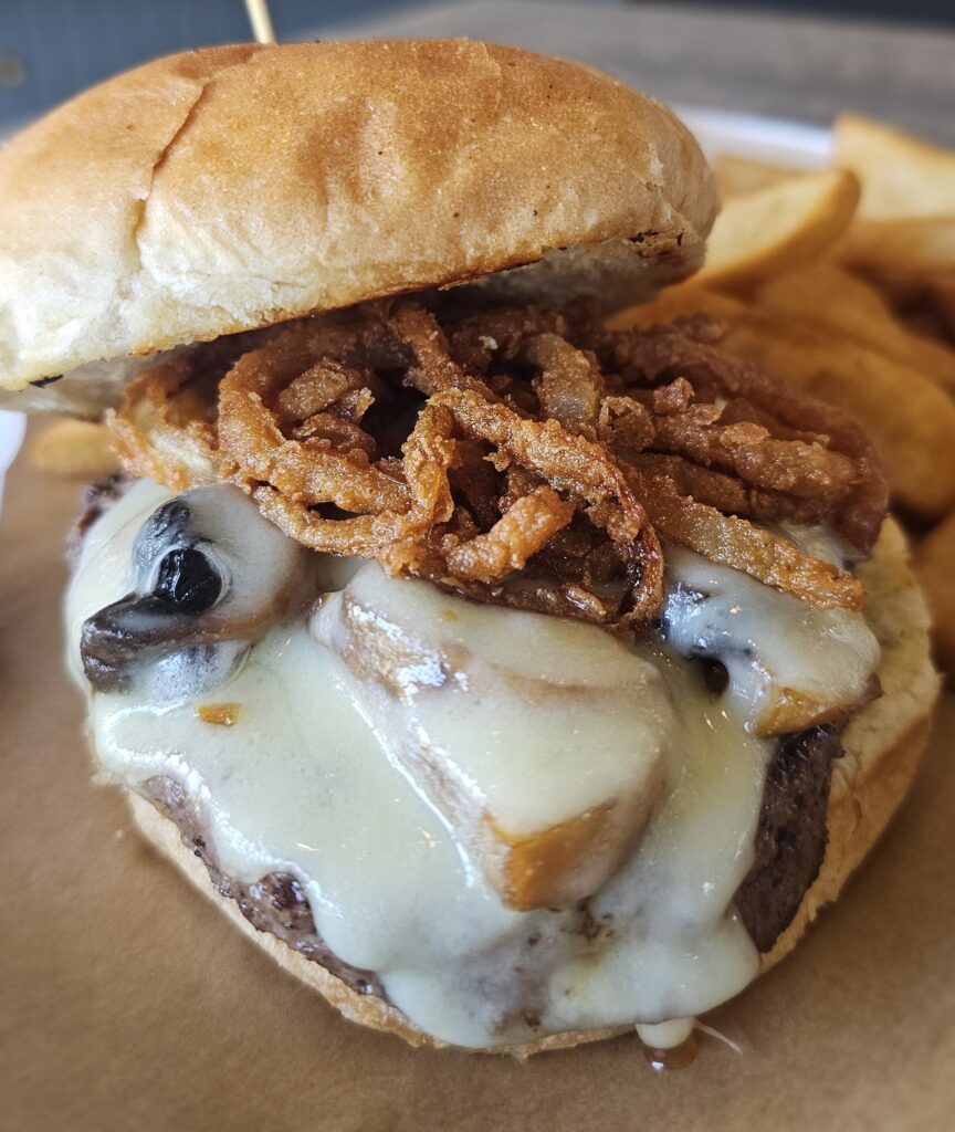 French Onion Burger: Our special house blend of sirloin, short rib & brisket ground to our specifications, lightly seasoned and grilled on a sizzling hot flat-top, topped with savory demi-glace with Swiss Cheese, mushrooms & crispy fried onions.