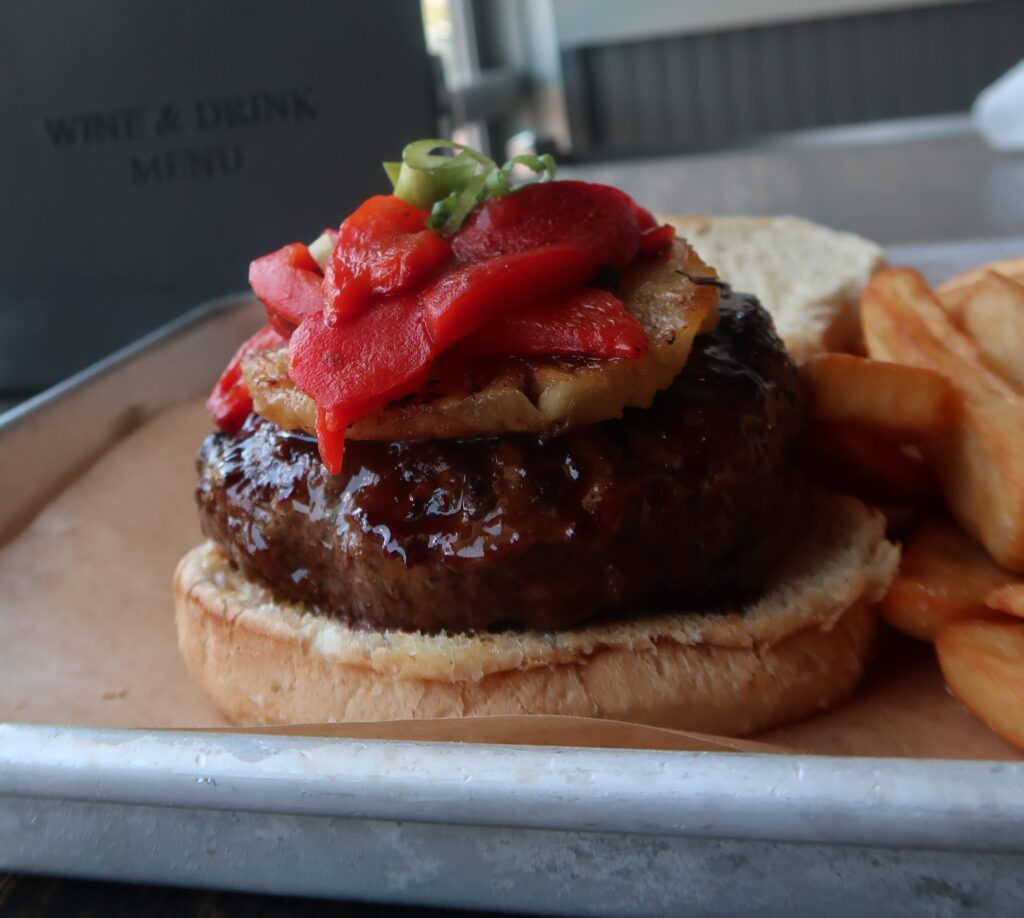 Hawaiian Burger: ½ pound of USDA choice ground sirloin, hand pressed & grilled to your liking, drenched with our sweet and savory teriyaki glaze, topped with grilled pineapple, sweet roasted red peppers and scallions.
