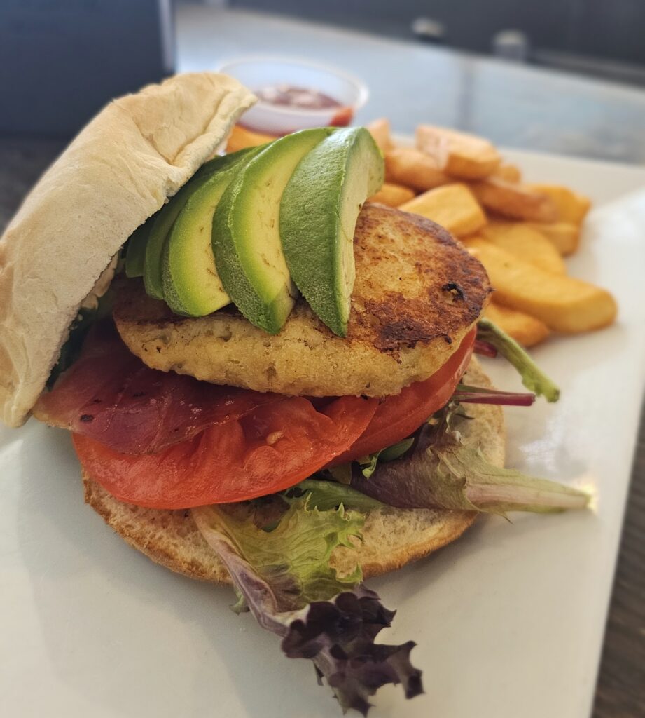 Crab Cake Sandwich: Lump crabmeat cakes seasoned & pan seared. Layered with mixed greens, tomato, avocado and thin sliced prosciutto with a drizzle of thousand island dressing on a toasted kaiser roll.