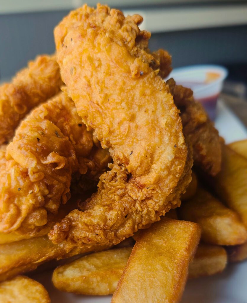 Crispy Tender Dinner: Fresh chicken tenderloins, hand-battered & fried to a crispy golden brown. Served with creamy coleslaw, steak fries & barbecue sauce.