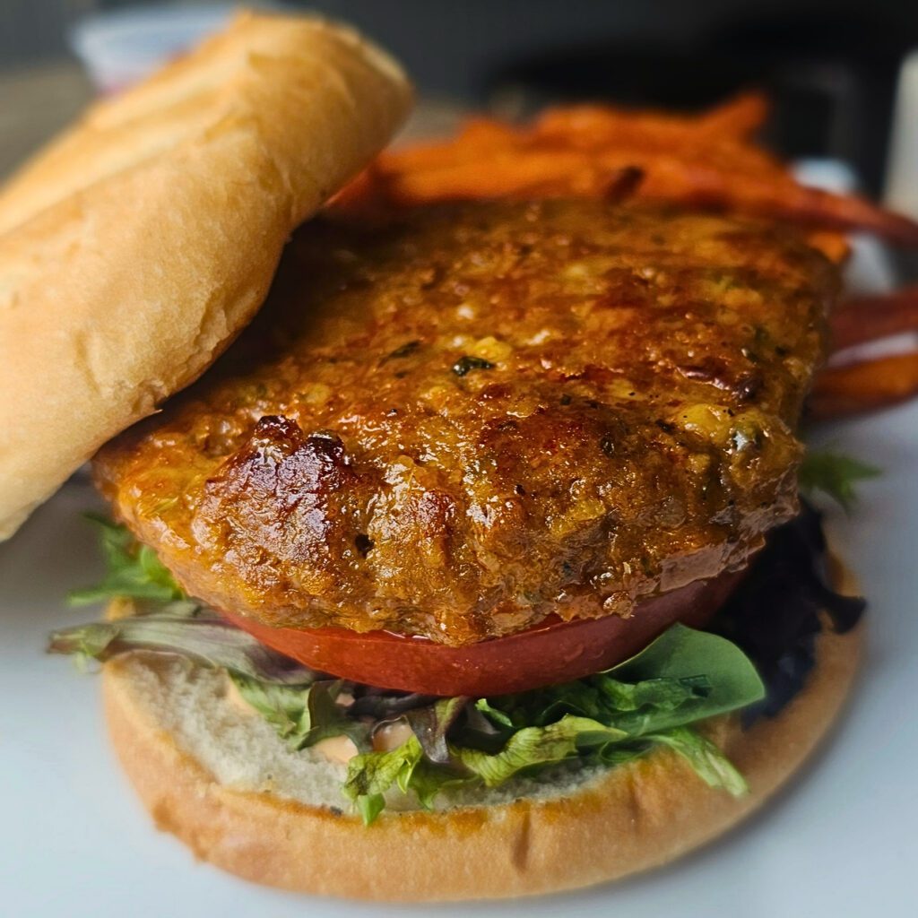 Turkey Burger: Ground turkey, mixed with Callah breadcrumbs, shaved parmesan cheese and seasonings then pan seared, layered with a drizzle of Thousand Island dressing, mixed greens & tomato. Served with sweet potato fries & cranberry sauce.