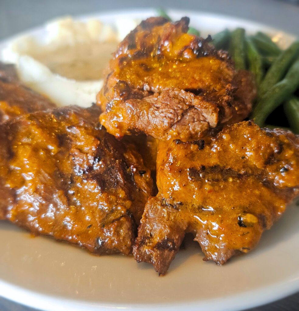 Sirloin Tips: Our Cuban inspired marinade makes these tips simply the best on the market, served with mashed potatoes, gravy & fresh vegetables.  Available in 8 oz. or 12 oz. portions