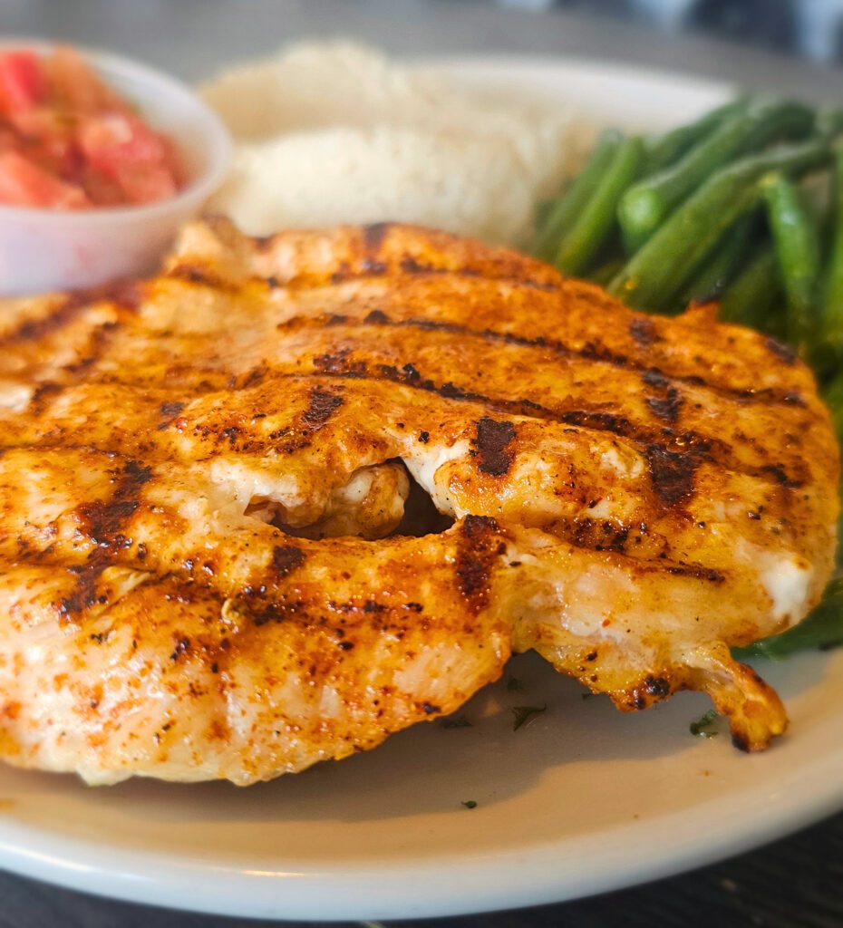 Grilled Chicken Breast:  Tender chicken with a touch of spice, grilled to perfection, served with Jasmine rice, house made Pico de Gallo & fresh vegetables.  Available in a single or double breast portion size.