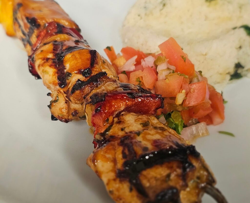 Chicken Teriyaki Skewers: Fresh cut chicken, skewered with peppers, onions and pineapple, with our chimichurri marinade, grilled over an open flame and finished with sweet teriyaki glaze & grilled pineapple, served with jasmine rice.  Available as a single or double skewer.