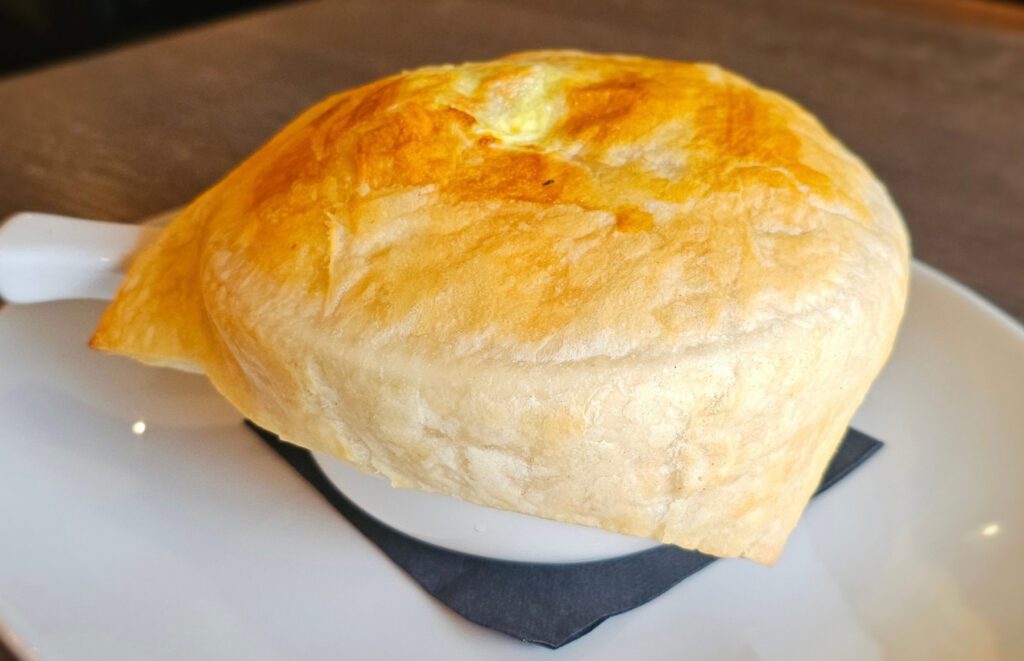Chicken Pot Pie: Chicken pot pie loaded with tender chicken, potatoes, carrots, mushrooms & peas in our homemade chicken gravy, with puff pastry.